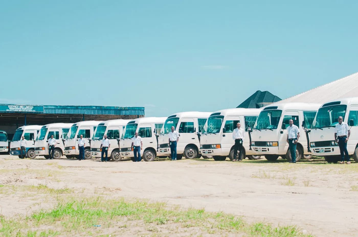 A row of goods vehicles parked in a depot yard.