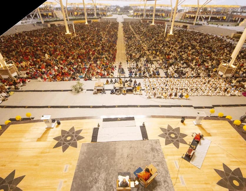 Aerial of a vast covered assembly floor laid out in patterned seating blocks.