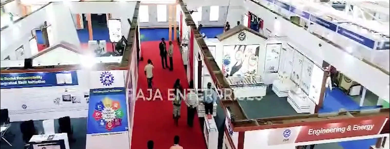Exhibition stalls and delegate walkways inside a clear-span hanger built by Raja Enterprises.